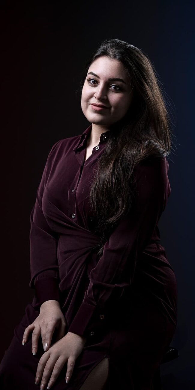 Model using hands to frame face during shoot