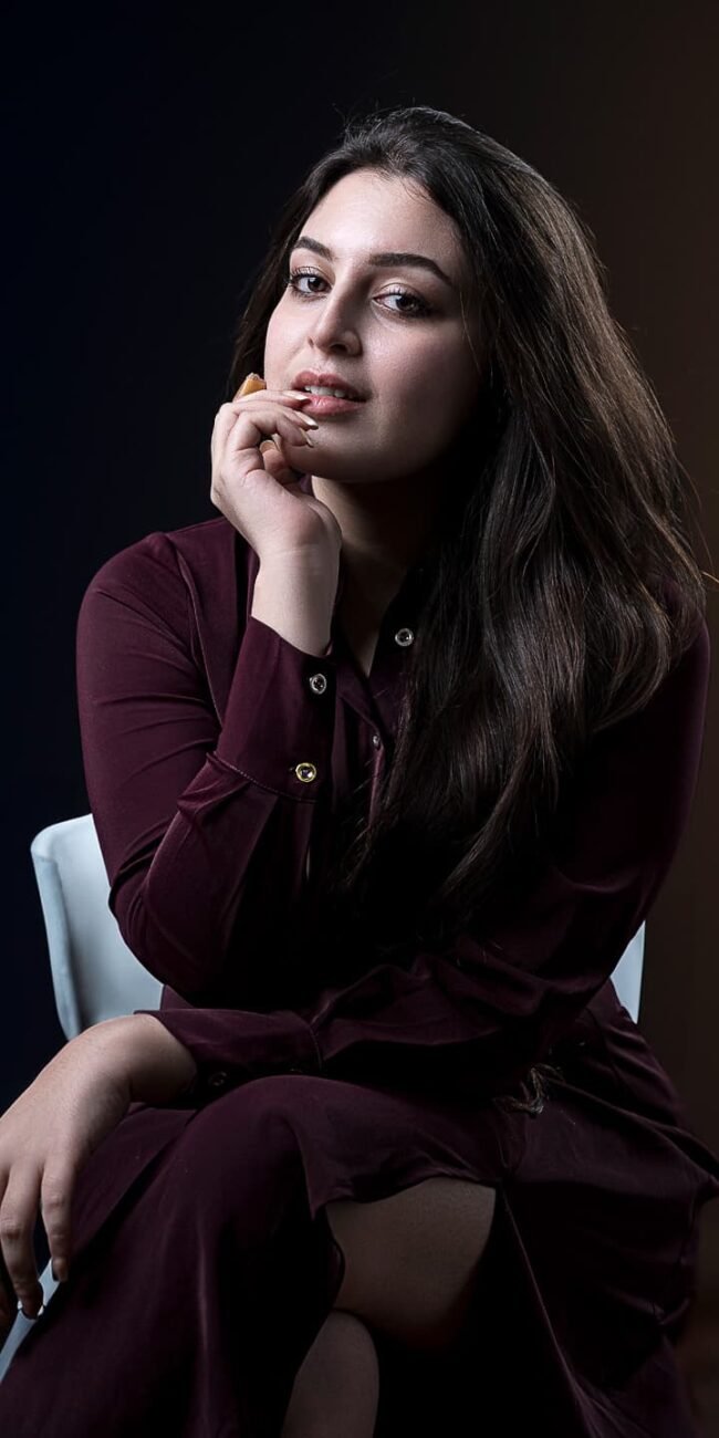 Strong eye contact with confident posture in studio