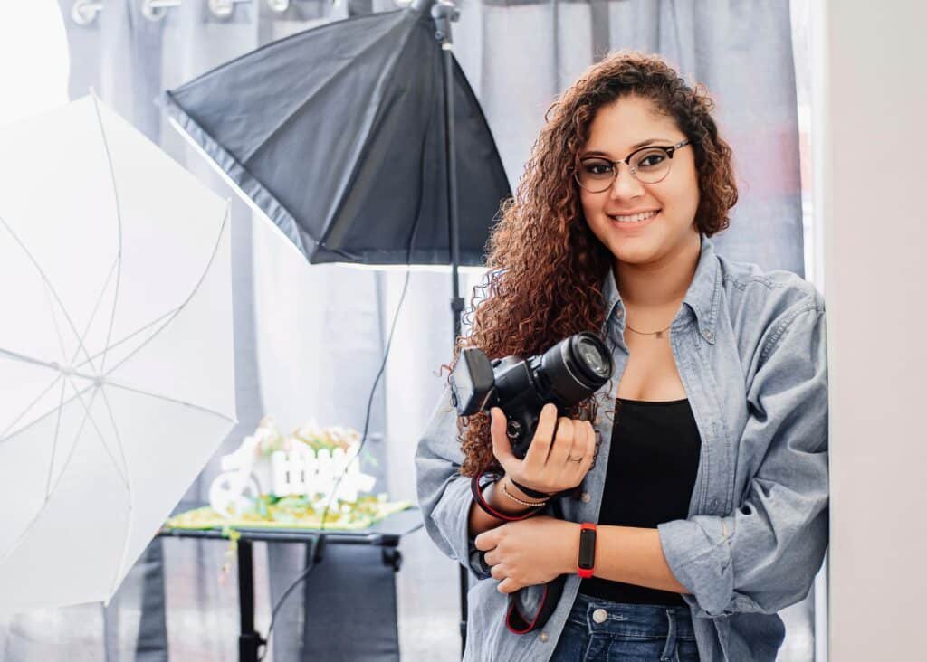 A photographer adjusting settings on a mirrorless camera during a photo session.
